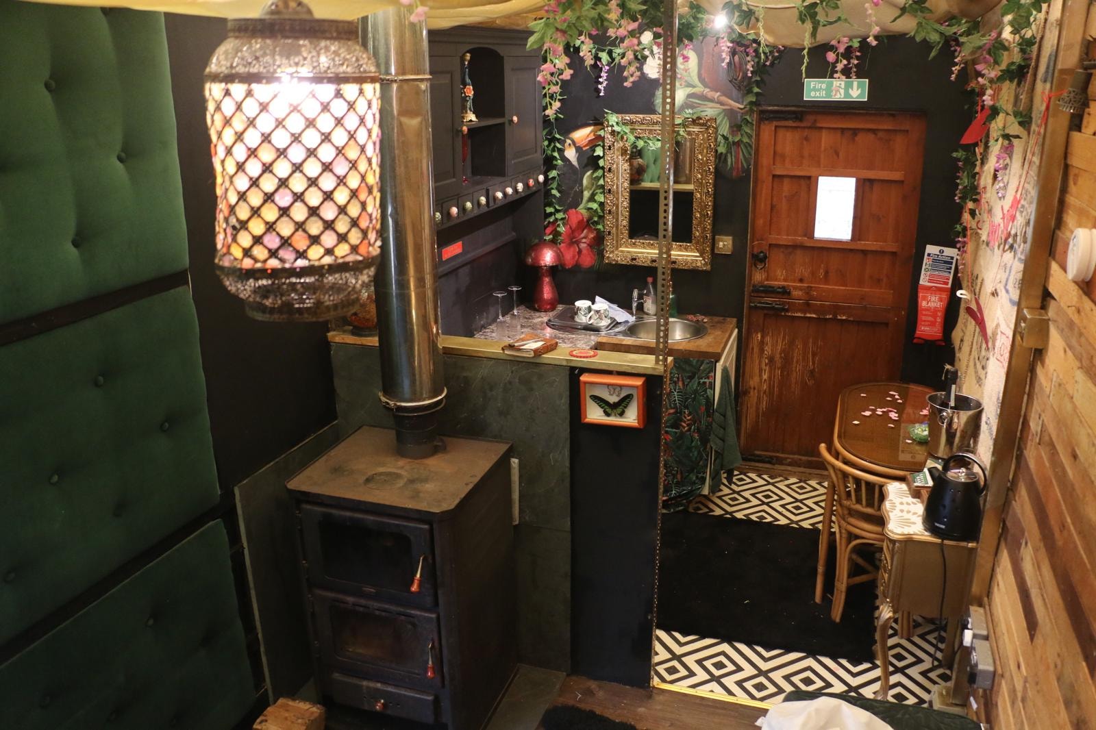 Tranquility Truck interior with Tiffany lamp and log burner