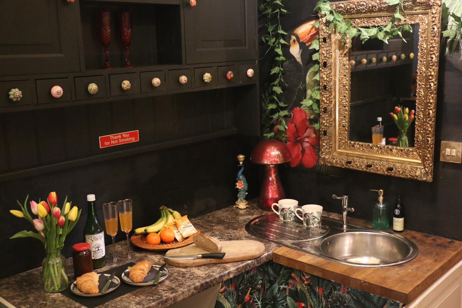 Vanity area with gold mirror and florals