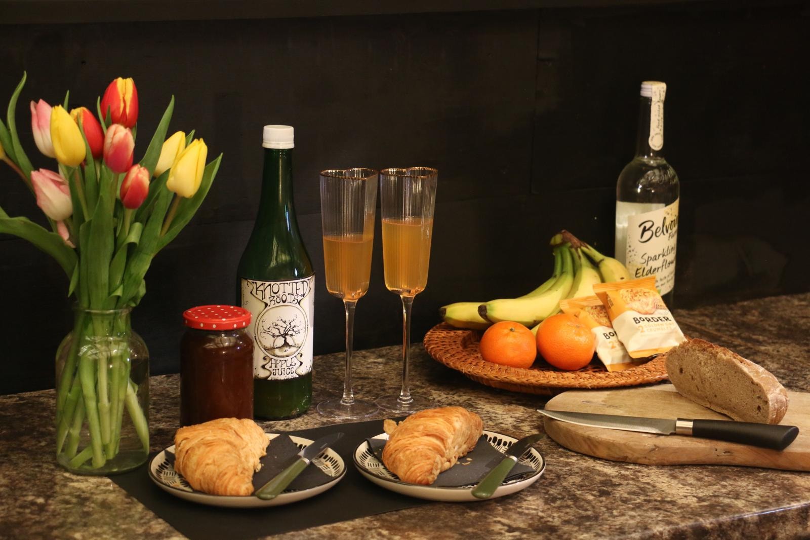 Breakfast spread with croissants, fruit and juice