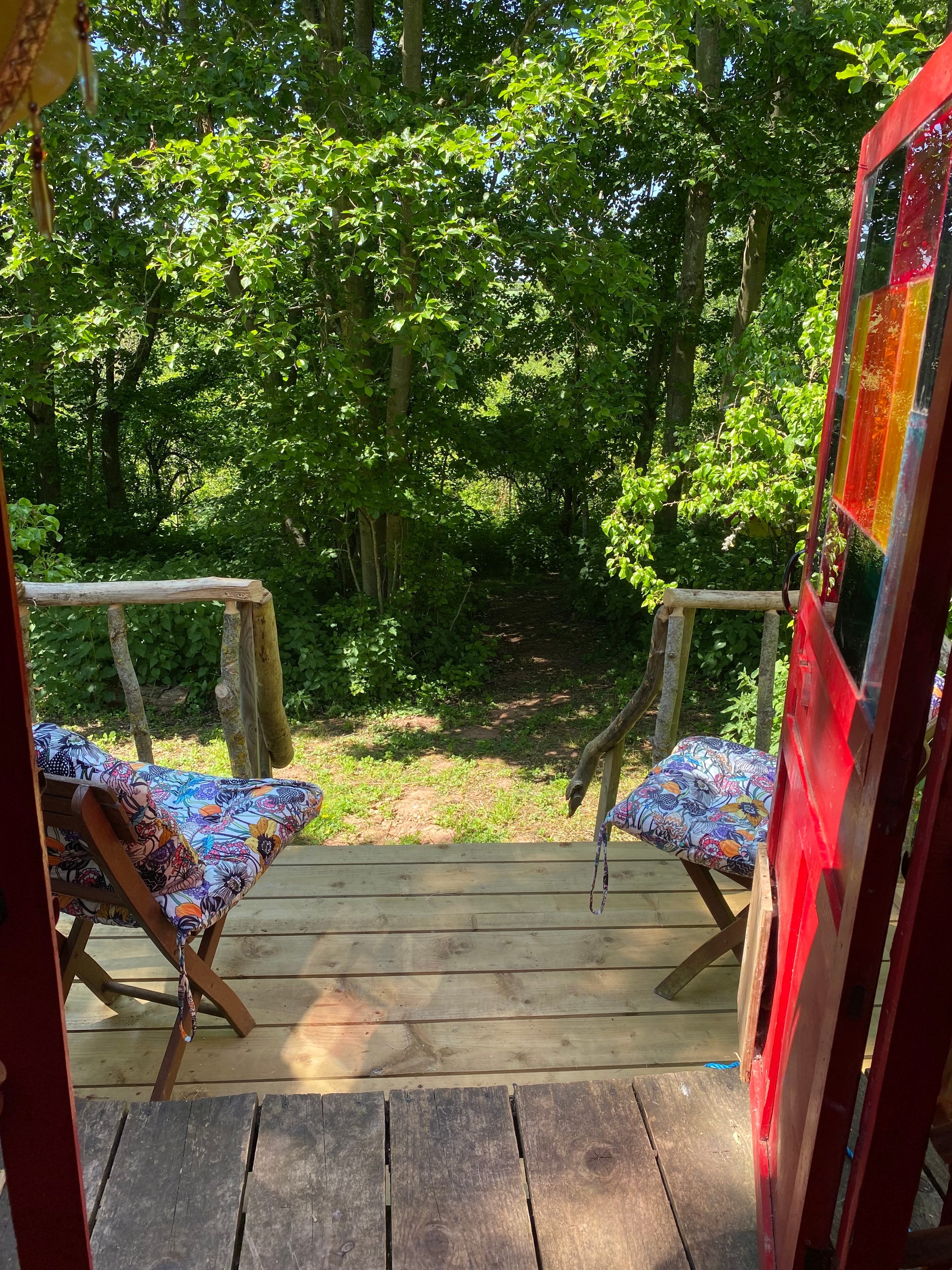 Colourful deck with floral chairs and stained glass roof