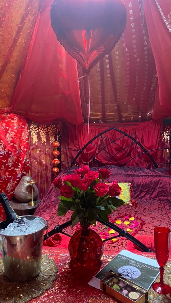 Romantic interior with roses, champagne and chocolates